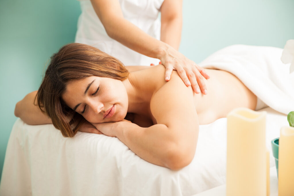 young woman enjoys massage spa