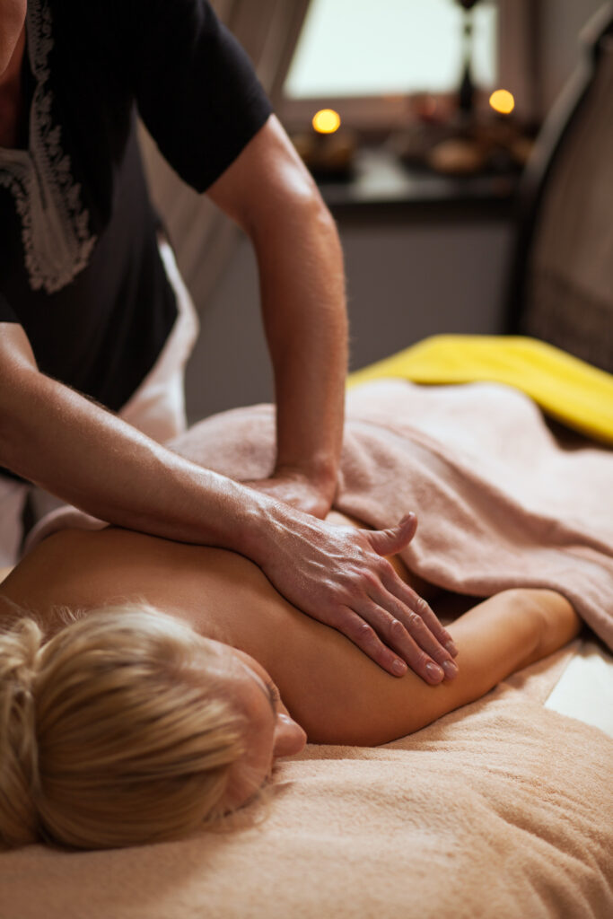 young woman enjoys massage spa